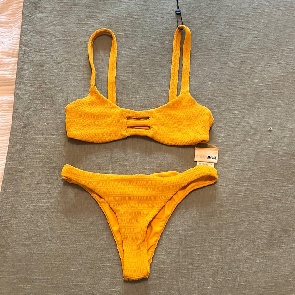 A yellow swimsuit it is an XS Has never been worn